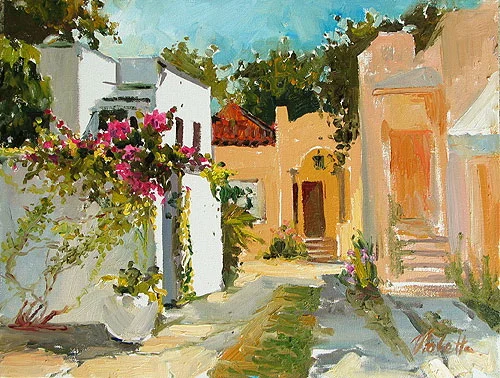 A sunlit village lane with white walls and flowering plants